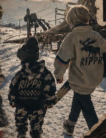 Two kids in RIPPR gear walking through snow